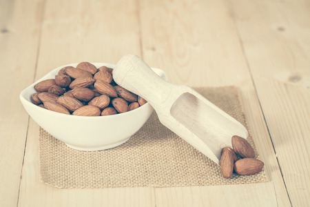 Almonds in bowl  on woodの写真素材