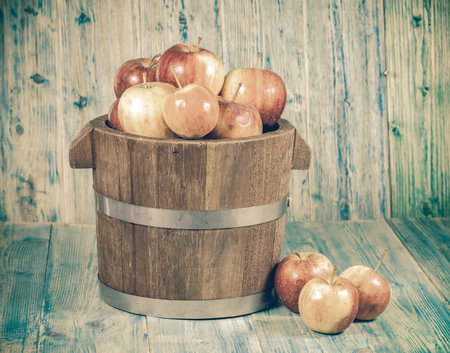Red apples in wooden bucketの写真素材