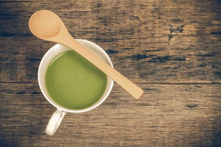 green tea with milk or hot matcha latte on woodの写真素材
