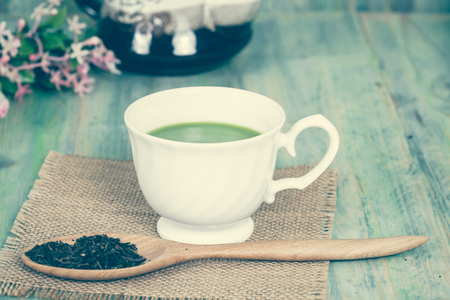 green tea with milk or hot matcha latte on woodの写真素材