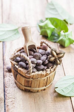 dried capsule seeds fruit of Sacha Inchi peanut in basket on 
woodの写真素材