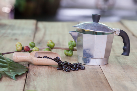 Fresh coffee beans on wood with a  moga potの写真素材
