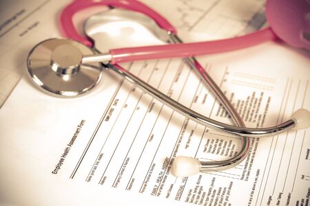 close up employee health assessment form and stethoscopeの写真素材