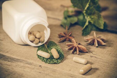 Organic Herb capsule medicine with mint leavesの写真素材