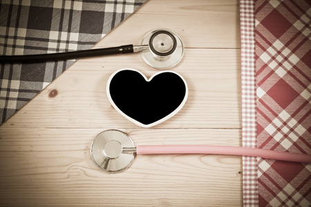 Close up wooden spoon and stethoscope  on wooden 
tableの写真素材