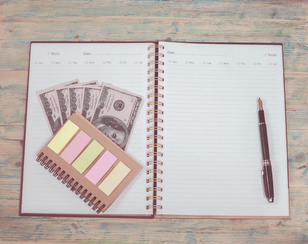 blank note book page and money, 100 hundred dollars 
and penの写真素材