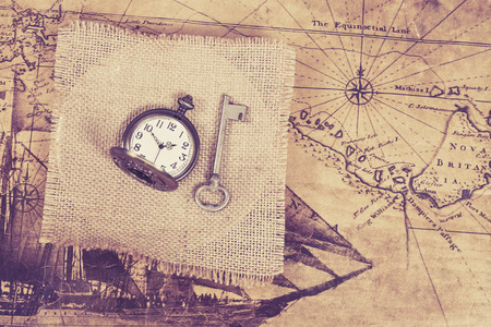 top view of old vintage pocket watch on burlap canvas .の写真素材