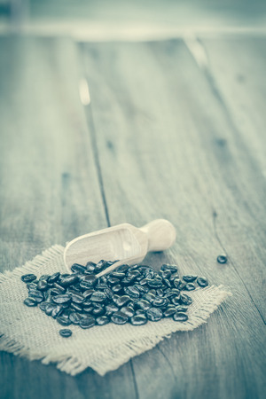 Fresh coffee and dry coffee beans on woodの写真素材