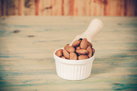 Almonds in bowl  on woodの写真素材