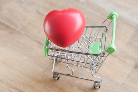 red heart ball in shopping cartの写真素材