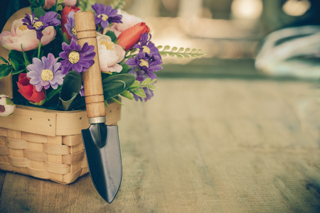flower in basket and garden toolの写真素材