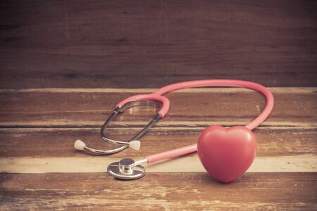 still life red heart and stethoscope on woodの写真素材