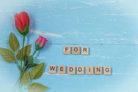 wonderful rose flowers on vintage wood background and text weddingの写真素材