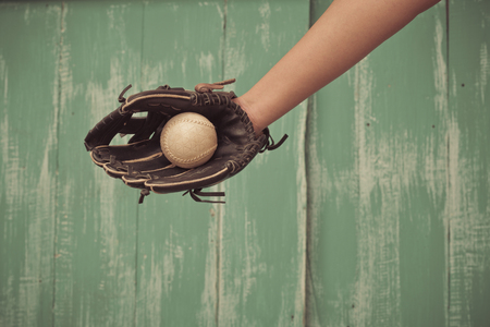 dirty and old baseball gloveの写真素材