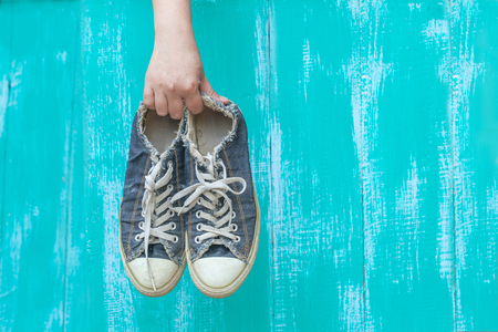 hand holding a dirty shoeの写真素材