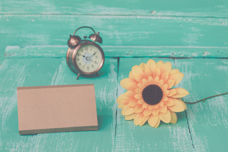 sunflowers and card on vintage wood