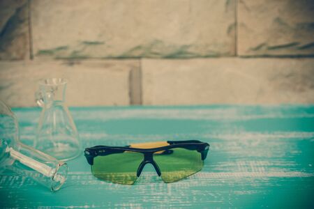 safety eye glasses on wood tableの写真素材