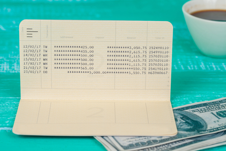 Book bank and money on wood