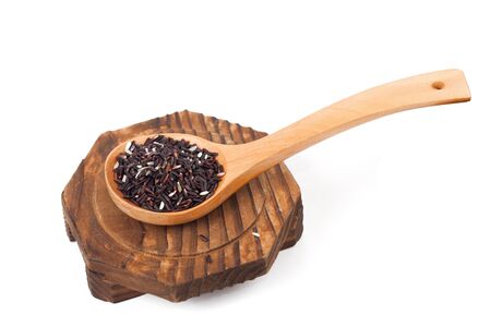Organic red rice in wooden spoonの写真素材