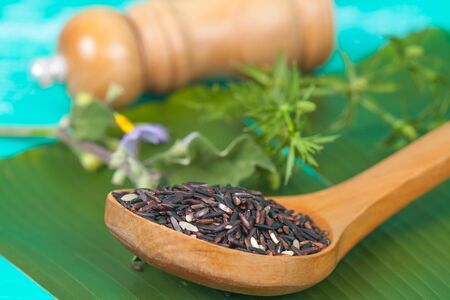 Organic red rice in wooden spoonの写真素材