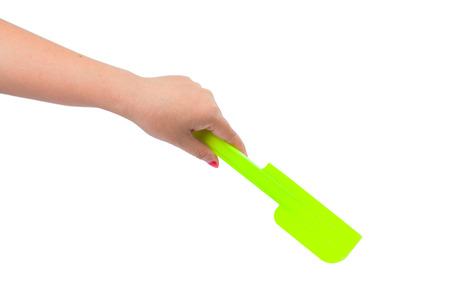Hand holding a spatula on white backgroundの写真素材