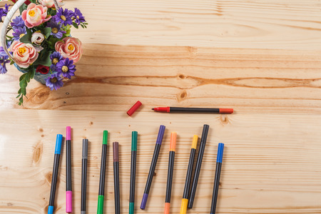 color pen on wood table with many equipment.の写真素材