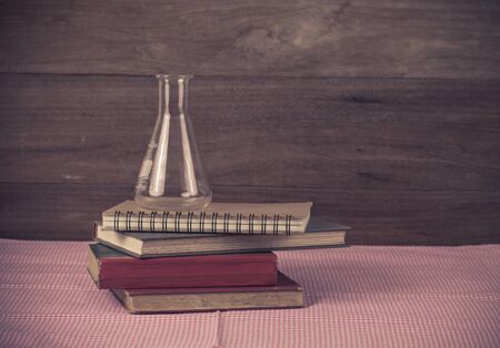 old book and tube on wood background.の写真素材