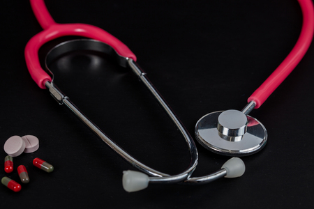 stethoscope and pill of medicine on backgroundの写真素材