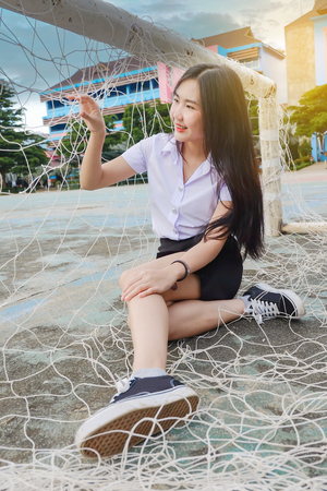 Young student girl in school uniform hold on 
sport net ,concept back to schoolの写真素材