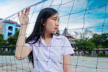young student girl in school uniform hold on sport net ,concept back to schoolの写真素材
