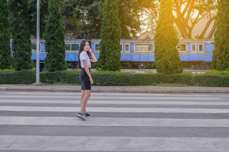 young student girl in uniform cross a street ,concept back to schoolの写真素材