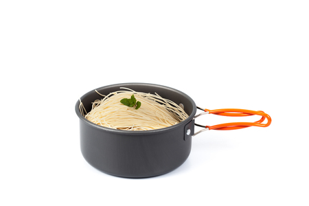 fire noodle in cooking pan or pot  on white background ,outdoor camping toolの写真素材