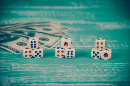 dice with bank note on color tableの写真素材