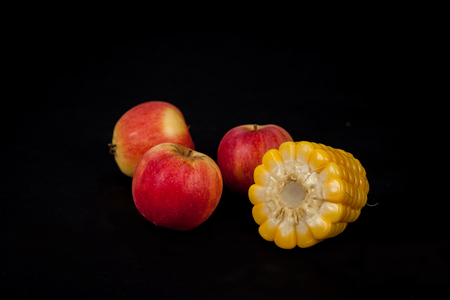 corn and apple on black backgroundの写真素材