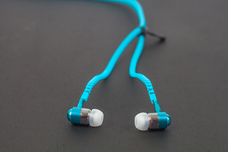 blue earphone and cable line like zipperの写真素材