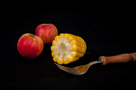 corn and apple on black backgroundの写真素材