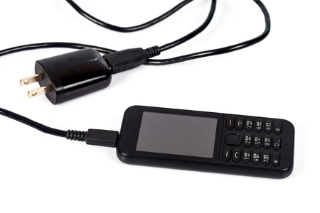 mobile with charger on white backgroundの写真素材