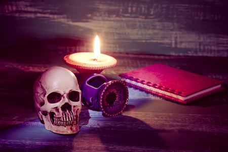 still life human skull and old book with candlestick の写真素材