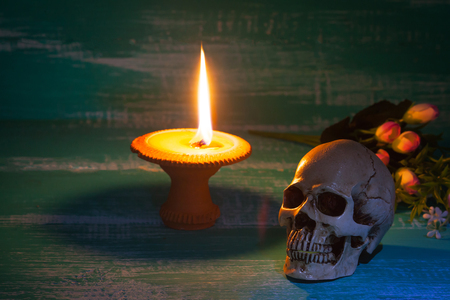 still life human skull on wood background with antique
candlestick 
の写真素材