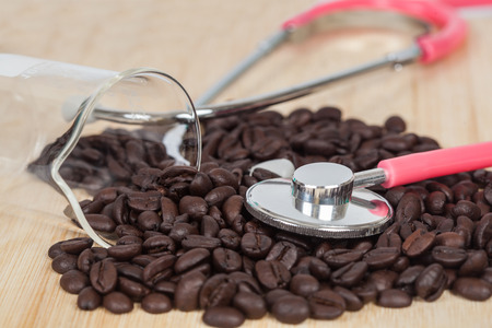 Stethoscope on dry coffee beans backgroundの写真素材