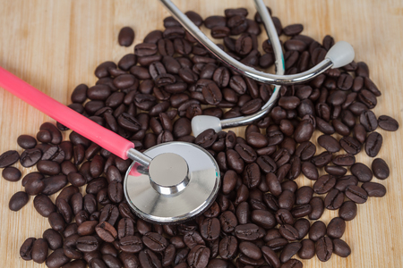 Stethoscope on dry coffee beans backgroundの写真素材