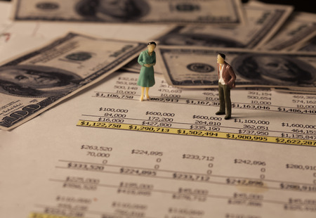 Miniature business man on income report and bank note,Image for business concept.