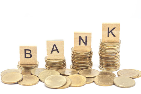 Word Bank Concept on wooden block over on stacked coins.の写真素材