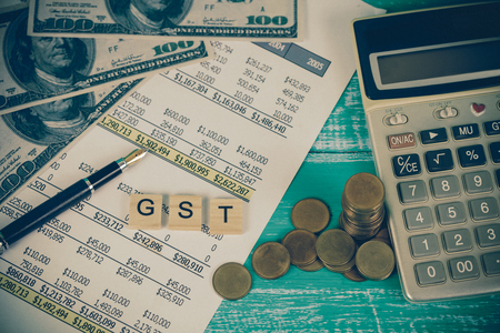 Goods and Services Tax word on paper sheet and currency . Financial concept.の写真素材