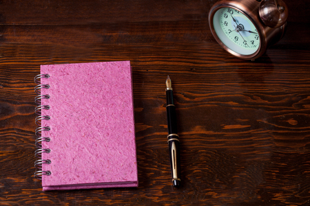 Colorful Book note and fountain pen on wood table.の写真素材