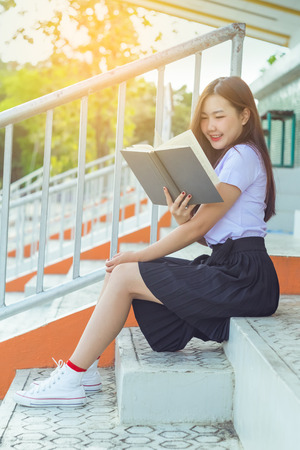 Teen Girl reading a text books on the stageの写真素材