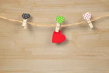 Handmade wood hearts hanging on cloth line or rope withの写真素材
