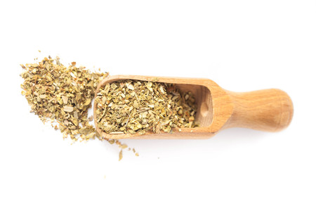 Dry Oregano herb in wood scoop on white background.の写真素材