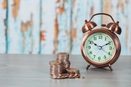 Close up of stacking coins with alarm clock ,Business Finance and Money concept,Save money for the future.の写真素材