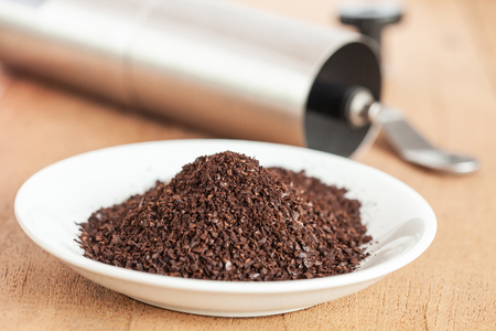 Coffee powder in white dish on wood table.の写真素材